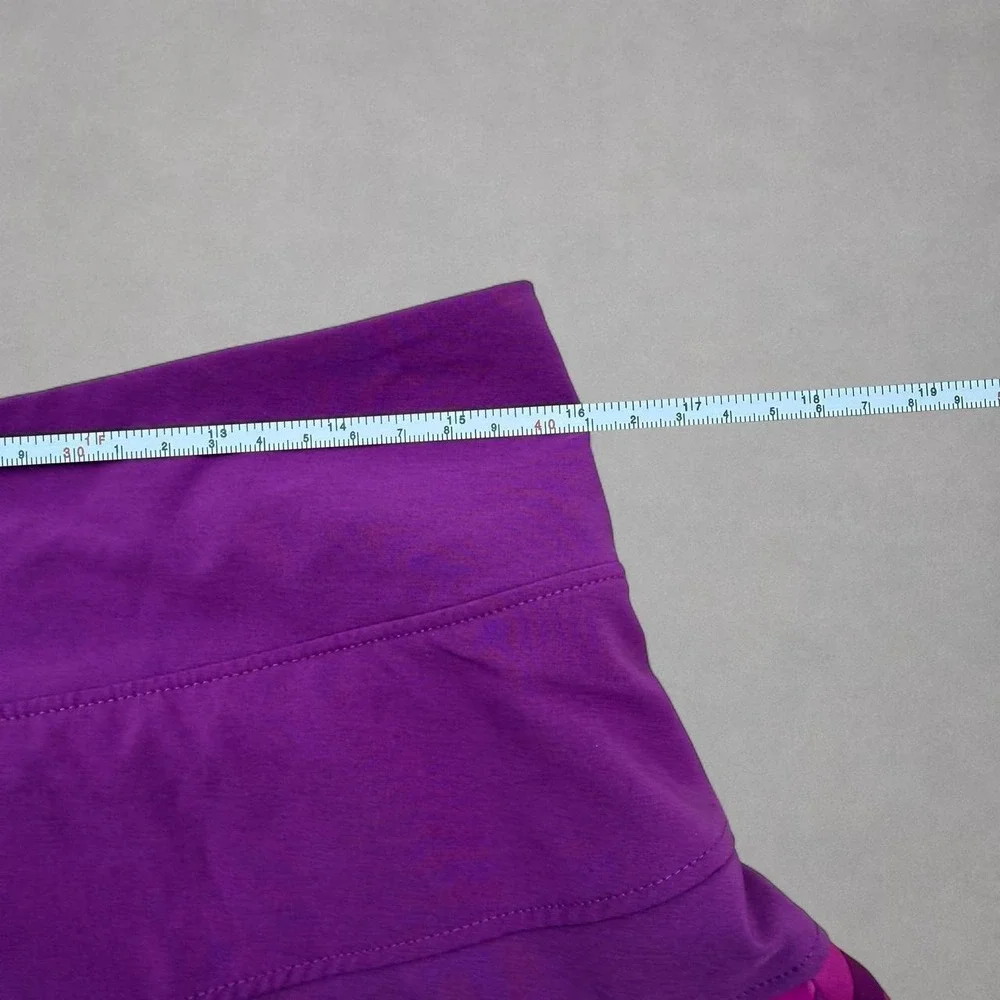 Nike purple tennis skort with diagonal stripes in shades of purple, size M